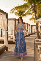 Woman wearing a blue and pink patterned dress.